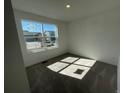 Bright bedroom featuring a large window offering plenty of natural light and neutral carpet at 22057 E 39Th Pl, Aurora, CO 80019