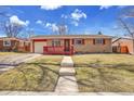 Inviting single-story home with a well-maintained lawn, red trim and accents under a bright blue sky at 435 S 42Nd St, Boulder, CO 80305