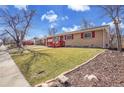 Well-kept single-story home with red trimmed windows and accents, and a manicured front lawn at 435 S 42Nd St, Boulder, CO 80305