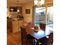 Cozy dining area featuring a wooden table set, hardwood floors, and a sliding glass door to the outdoor area at 995 W Peakview Cir, Littleton, CO 80120