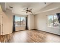 Bright, spacious bedroom featuring wood floors, a ceiling fan, and sunlit views at 9139 W 50Th Ln # 204, Arvada, CO 80002