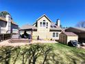 Relaxing backyard featuring a deck, shed and green space perfect for entertaining and storage at 13474 W 65Th Dr, Arvada, CO 80004