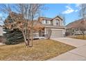 Charming two-story home boasts a well-maintained front yard and a two-car garage at 19629 E Elk Creek Dr, Parker, CO 80134