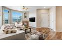 Inviting living room with a fireplace, large windows, and hardwood floors at 5705 N Genoa Way # 206, Aurora, CO 80019