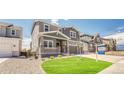 Beautiful two-story home boasts a manicured lawn and inviting front porch, perfect for relaxing outdoors at 3008 Blithe Pt, Castle Rock, CO 80108