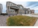 Beautiful home with well-maintained lawn and landscaping, stone accents, covered porch, and three-car garage at 3008 Blithe Pt, Castle Rock, CO 80108