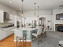 Bright kitchen featuring a large island, pendant lights, hardwood floors and stainless appliances at 23327 E Ottawa Dr, Aurora, CO 80016