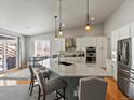 Eat-in kitchen boasts a large island, modern stainless appliances, and hardwood floors at 23327 E Ottawa Dr, Aurora, CO 80016
