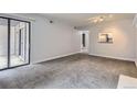 Living room showcasing access to balcony and a pass-through to the kitchen at 9867 E Peakview Ave # E1, Englewood, CO 80111