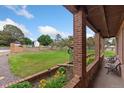 Charming front porch with brick columns, flower planters, and seating area at 11485 Pecos St, Denver, CO 80234