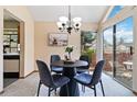Charming dining area with backyard views and a modern chandelier at 2136 S Scranton Way, Aurora, CO 80014