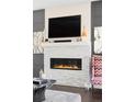 Modern fireplace with white stone surround and decorative mantle. Black framed TV mounted above at 3255 S Birch St, Denver, CO 80222