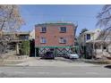 Three-story brick building with parking underneath, staircase, and possible rooftop deck at 1140 N Downing St # 303, Denver, CO 80218