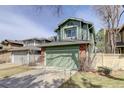 Inviting green exterior showcasing a two-story home with an attached two-car garage and brick accents at 8254 S Gaylord Cir, Centennial, CO 80122