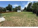 Large backyard with mature trees and a shed, offering plenty of space for outdoor activities at 10630 W 46Th Ave, Wheat Ridge, CO 80033