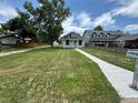 A wide view of the property showing the house, lawn, and neighborhood at 10630 W 46Th Ave, Wheat Ridge, CO 80033