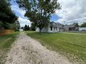 View of house and driveway, with mature landscaping and a neighboring house at 10630 W 46Th Ave, Wheat Ridge, CO 80033