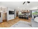 Open concept living room and kitchen with island seating, hardwood floors, and modern lighting at 7724 S Lafayette Ct, Centennial, CO 80122