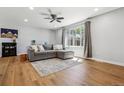 Inviting living room with hardwood floors, natural lighting, and comfortable sectional couch at 7724 S Lafayette Ct, Centennial, CO 80122