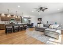 Open concept living room and kitchen area with hardwood floors and natural light at 7724 S Lafayette Ct, Centennial, CO 80122