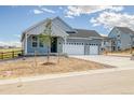 Beautifully designed home showcasing a well-manicured front yard and inviting entrance at 39628 Yorktown Ter, Elizabeth, CO 80107