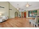 Bright living room features hardwood floors, a vaulted ceiling, and a large window at 6307 S Gallup St, Littleton, CO 80120