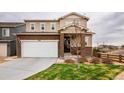 Charming two-story home features a two-car garage and a well-maintained front lawn at 2028 Trail Stone Ct, Castle Rock, CO 80108