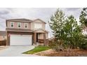 Beautiful two-story home with an attached garage and a well-manicured lawn at 2028 Trail Stone Ct, Castle Rock, CO 80108