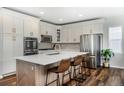 Modern kitchen boasts stainless steel appliances, white cabinetry, and a spacious center island at 2028 Trail Stone Ct, Castle Rock, CO 80108