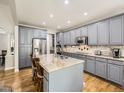 Bright kitchen with stainless steel appliances and grey cabinetry at 14310 Kalamath St, Westminster, CO 80023