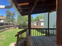 A covered back porch overlooks the home's spacious fenced-in backyard at 17477 E Temple Dr, Aurora, CO 80015