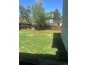 Spacious backyard with a wood fence providing privacy at 17477 E Temple Dr, Aurora, CO 80015