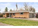 Well-maintained brick home with lush lawn, mature trees, and an attached garage at 11223 W 29Th Ave, Lakewood, CO 80215