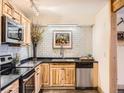 Updated kitchen features stainless steel appliances, butcher block counters, and modern tile backsplash at 400 Zang St # 1-105, Lakewood, CO 80228