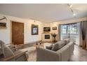 Cozy living room with fireplace, sliding doors to balcony, and modern decor at 400 Zang St # 1-105, Lakewood, CO 80228
