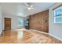 Bright living room with hardwood floors and exposed brick wall at 2528 N Gilpin St, Denver, CO 80205