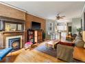 Living room features hardwood floors, exposed brick, and a fireplace at 2528 N Gilpin St, Denver, CO 80205