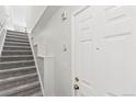 Bright entryway with carpeted stairs and white walls offering a welcoming ambiance at 1631 Egret Way, Superior, CO 80027