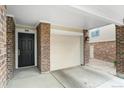 Attached garage with direct access to the home's entry, featuring brick accents and a convenient layout at 1631 Egret Way, Superior, CO 80027