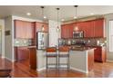 Open kitchen with island, granite countertops, and stainless steel appliances at 2189 S Nile St, Lakewood, CO 80228