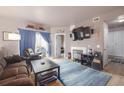 Inviting living room with hardwood floors, a fireplace, and sliding glass doors to a private patio at 8707 E Florida Ave # 410, Denver, CO 80247