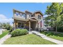 Charming two-story home with landscaped yard and inviting front porch with wood accents at 4180 Ames St, Denver, CO 80212
