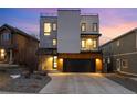 Modern three-story home with a rooftop deck and stone and white stucco facade with a two car garage at 9742 Fairwood St, Littleton, CO 80125