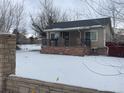 Ranch style home with a covered porch and stone pillars at 2561 W Dartmouth Ave, Denver, CO 80236