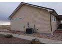 Side view showcasing the home's light beige siding and landscaping at 47855 E 88Th Ave, Bennett, CO 80102