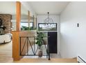 Modern entryway featuring wood accents, unique light fixture, and a view of the landscape at 26 Morningside Dr, Wheat Ridge, CO 80215