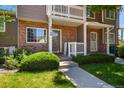 Charming townhouse with brick facade, manicured lawn and a 'Welcome' sign at 4574 S Cimmarron Cir # B, Aurora, CO 80015