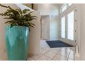 Bright entryway with tile flooring, double doors, and a decorative plant at 400 S Steele St # 13, Denver, CO 80209