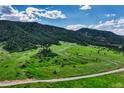 Expansive acreage featuring gently rolling hills, lush green pastures, scattered trees, and the serenity of country living at 15533 S Perry Park Rd, Palmer Lake, CO 80133