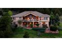 Beautifully landscaped two story home with a large balcony and outdoor space at 15533 S Perry Park Rd, Palmer Lake, CO 80133